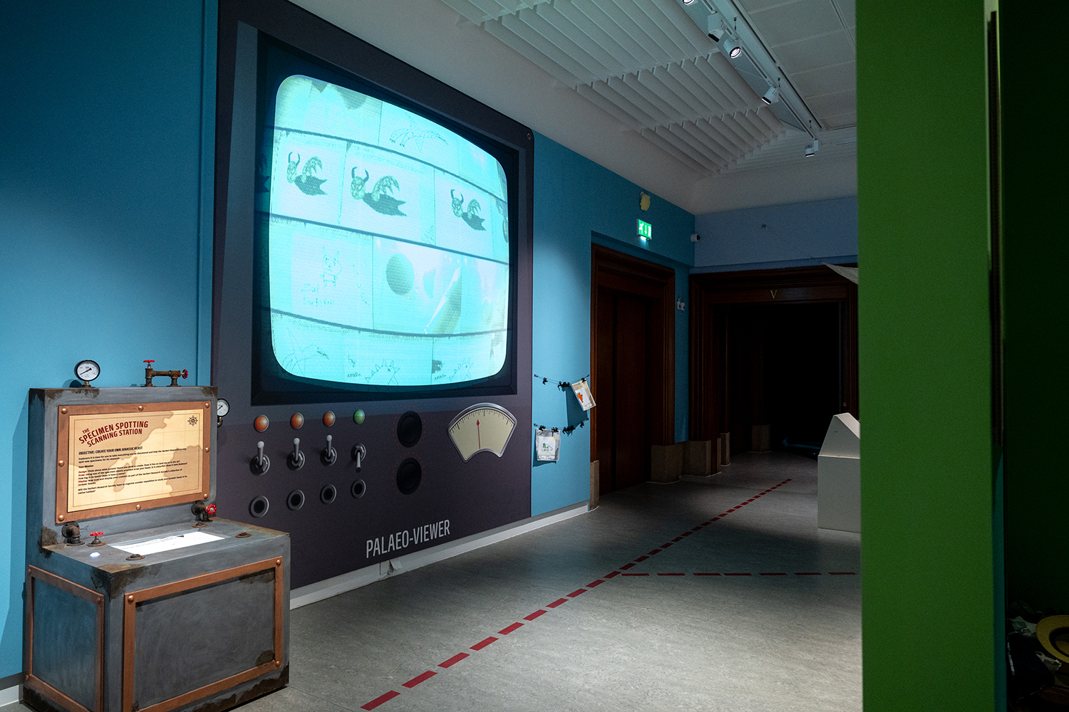 A huge TV is displayed on the gallery wall showing images that have been scanned animating on the wall